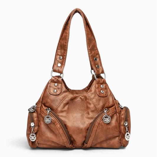 Sac à main noir compact porté à l'épaule, style urbain discret