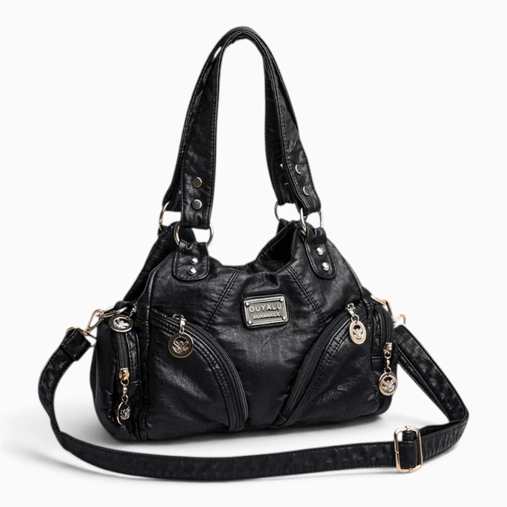 Petit sac à main noir porté en bandoulière, allure quotidienne élégante