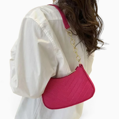 Sac bandoulière compact porté en travers, design affirmé en feutre orange