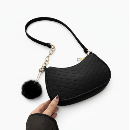 Bandoulière femme format compact noir en feutre, détail de la forme selle
